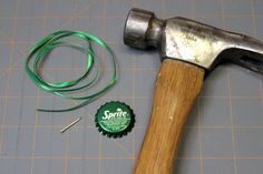 a hammer with a green ribbon next to it