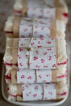 several pieces of cake sitting on top of a white plate with red and white decorations