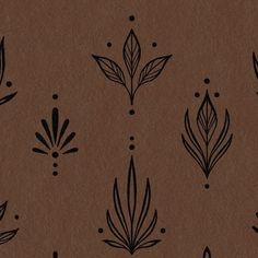 a brown paper with black leaves and dots on the bottom half is shown in this image