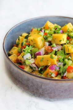 a bowl filled with chopped vegetables on top of a table