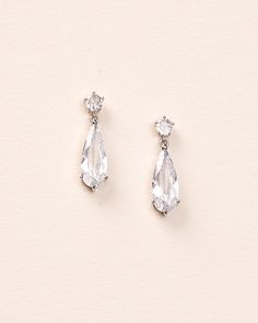 two pairs of earrings with clear stones on the bottom and one has a large tear shaped drop