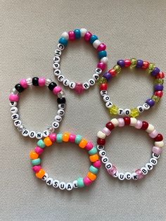 four different bracelets with words on them