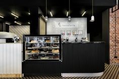 the interior of a restaurant with black and white checkered flooring, brick walls and exposed lighting