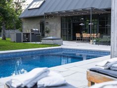 a backyard with a swimming pool and patio furniture