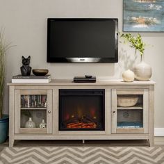 an entertainment center with a flat screen tv and fireplace