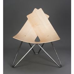 a wooden chair with metal legs and two pieces of wood in the shape of a house