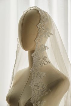 a mannequin with a veil on top of it