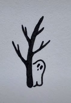 a black and white drawing of a tree with a ghost drawn on it's trunk