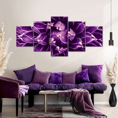 a living room with purple couches and large paintings on the wall above each sofa