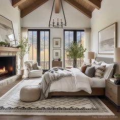 a bedroom with a large bed and fireplace in it