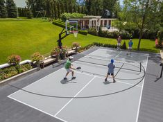 people playing tennis on an outdoor court in the backyard with basketball hoop and chairs around it