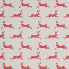 a red and white wallpaper with running rabbits on it's back side,