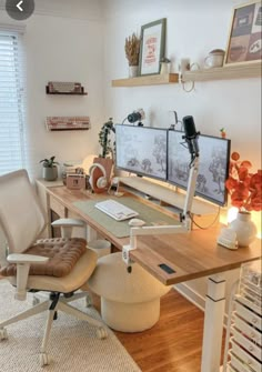 a home office with two computer screens on the desk