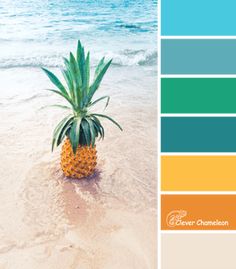 a pineapple sitting on top of a sandy beach next to the ocean with color swatches