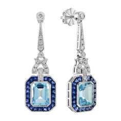 A pair of emerald cut blue topaz stones, precisely matched by eye, totaling 5.90 carats, and set into a pair of exquisite drop ear studs. These exquisite earrings are complimented by 3.78 carats of French cut blue sapphire and round diamonds finished into 14k white gold. Earrings Information Metal: 14K White Gold Width: 12 mm. Length: 39 mm. Weight: 8.50 g. (approx. in total) Backing: Push Back Center Gemstones Type: Blue Topaz Shape: Emerald Cut Size: 9x7 mm. Number: 2 Weight: 5.90 Carat (appro Deco Earrings, Gem Jewelry, Blue Topaz Stone, Art Deco Earrings, White Gold Earrings, Topaz Stone, Estilo Art Deco, Deco Jewelry, Gems Jewelry