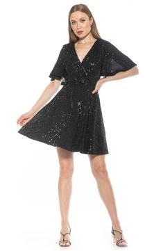 Sparkling sequins adorn a fit-and-flare skater dress in soft stretch velvet for glamorous style. 36 7/8" length (size X-Small) Surplice neck Flutter sleeves Back keyhole with button-loop closure Elasticized waist Sequin velvet construction Flared silhouette Lined Shell: 90% polyester, 10% spandex/lining: 100% polyester Hand wash cold, line dry Imported Flounce Skirt, Glamorous Style, Flutter Sleeve Dress, Stretch Velvet, Sweaters And Leggings, Black Xs, Flutter Sleeves, Dress Romper, Cocktail Dress Party