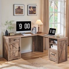 a corner desk with two computer monitors and a lamp on it in front of a window