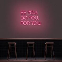 three stools in front of a neon sign that says be you do you for you