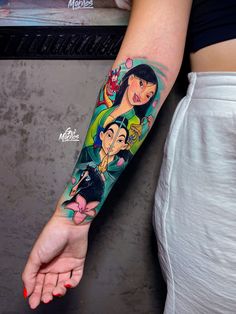 a woman's arm with tattoos on it and an image of the character from avatar