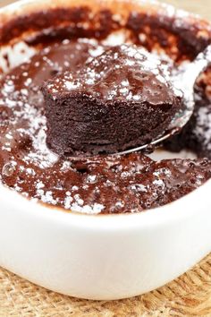 chocolate cake in a white bowl with a spoon