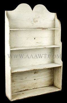 an old white wooden shelf with two shelves on it's front and back sides