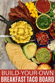 a plate full of food with the words build your own breakfast taco board