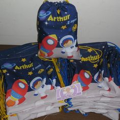 several diapers stacked on top of each other in front of a wall with space theme