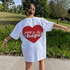 a woman wearing a white shirt that says going to the chapel