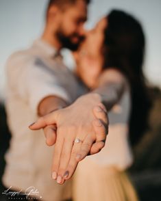 a close up of a person holding the hand of another person with their fingers together