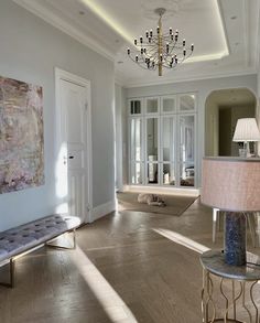 a living room filled with furniture and a chandelier