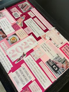 a table topped with lots of pink and white papers