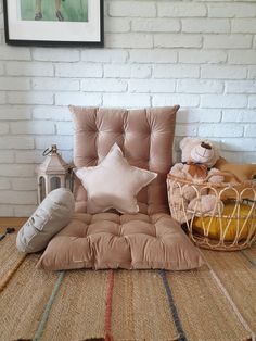 a chair with pillows and other items on it in front of a white brick wall