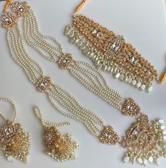 A must have for the upcoming wedding season! This bridal set is a unique blend of royal and modern with its pastel hues and gold plating. The set is gorgeous with pearls and is a full bridal piece but can be worn separately for a lighter and simple look. Set includes: mala , earrings, maang tikka , passa, choker In stock and ready to ship‰Û? I have a separate listing for the champagne gold color Gold Bollywood Sets With Pearl Embroidery, Gold Sets With Pearl Embroidery For Reception, Elegant Wedding Sets With Tilla Details, Elegant Tilla Wedding Sets, Elegant White Tilla Sets, Elegant White Sets With Tilla Detailing, Elegant Gold Set With Pearl Embroidery, Wedding Pearl Jewelry Sets With Pearl Chain, Elegant Gold Bridal Accessories With Tilla