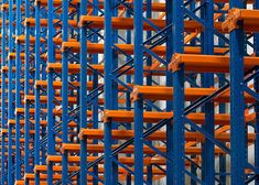 orange and blue shelves in a large warehouse