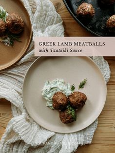 some meatballs are on a plate with sour cream and dill sprig