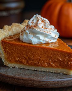 a slice of pumpkin pie with whipped cream on top