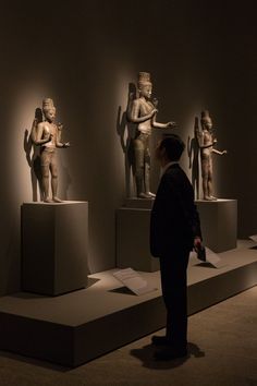 a man standing in front of some statues