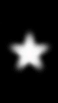 a blurry image of a white star in the dark