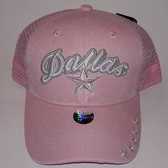 a pink baseball cap with the word dallas on it's front and silver stars at the peak