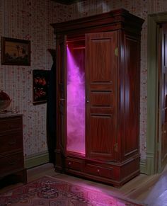 an armoire with pink light coming from it