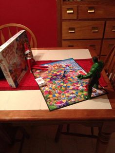 a wooden table topped with a book and toy figurine on top of it