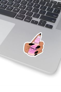 a laptop computer with a sticker on the keyboard that has a hand holding a camera