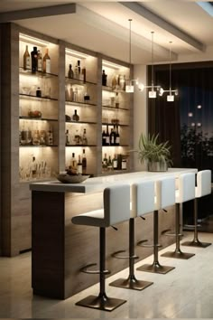 a bar with several stools and bottles on the shelves behind it in a room