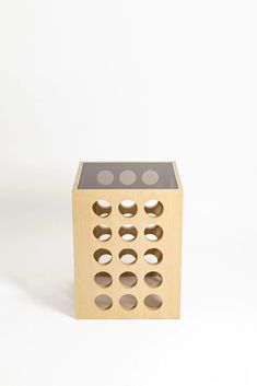 a wooden box with holes cut out of it