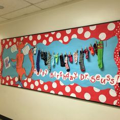 a happy birthday dr seuss bulletin board with clothes hanging from it's hooks