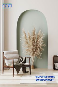 a living room with a chair and a vase on the floor in front of a wall