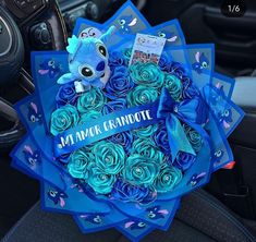 a bouquet of blue roses in the center of a car