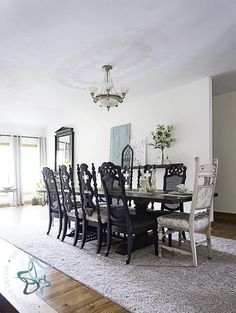 a dining room table with chairs and a chandelier