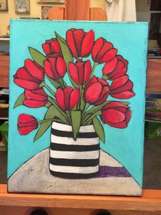 a painting of red flowers in a black and white striped vase on a blue background