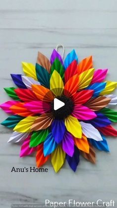 an origami flower made out of colored paper